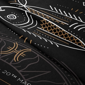 Close-up of soft black velvet Pisces tapestry featuring gold scales and zodiac symbols