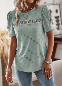 Close-up of mint green blouse featuring hollow lace patchwork and puffy short sleeves