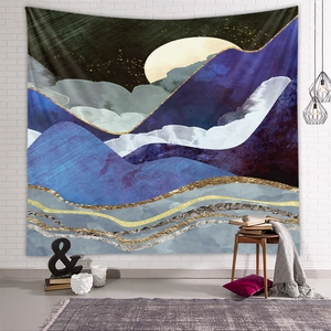 Detailed view of an abstract mountain tapestry with golden lines on a white brick wall