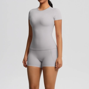 Detail of grey short sleeve yoga top and high waist leggings showing smooth fabric texture
