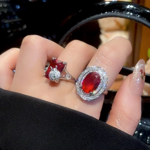 Luxury open rings with faux ruby center stones and full diamond pavé on model's hand