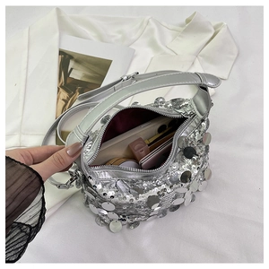 Interior detail of silver sequin handbag showing storage for phone and lipstick
