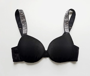 Detail of black velvet push-up bra featuring rhinestone LOVE SECRET embellished straps