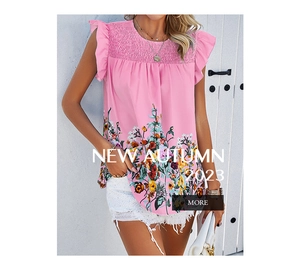 Detail of pink sleeveless blouse featuring ruffled sleeves and colorful floral print hem