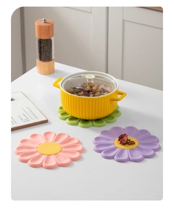 Detail of floral silicone heat resistant pads in pastel colors for table protection