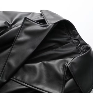 Close-up of lapel collar and fine leather texture on long black trench coat for women