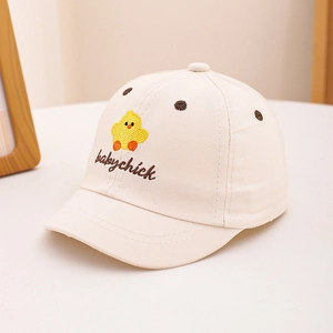 Close-up of cute yellow chick and babychick embroidery on cream cotton baby baseball cap