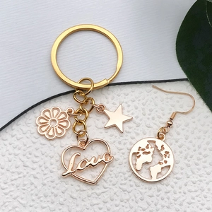 Antique gold alloy keychain and earring set with heart, star, flower and globe charms
