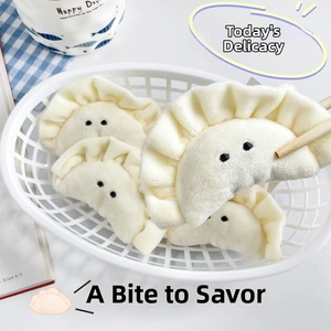 Detailed macro view of a cute plush dumpling charm held by chopsticks in a basket