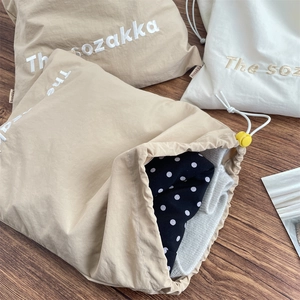 Macro detail of The sozakka drawstring storage bags showing fabric texture and yellow stoppers