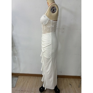 Detail of white corset dress featuring 3D butterfly appliqués and side ruching texture