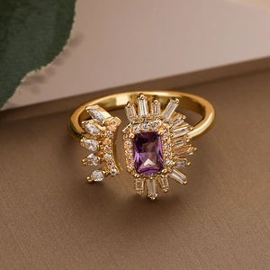 Gold plated geometric open ring featuring a purple rectangular zircon and sunburst accents