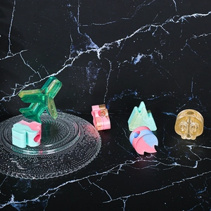 Macro view of assorted resin charms with gold glitter for DIY jewelry making and crafts
