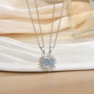 Detailed view of silver sun and moon pendant with blue and white zircon stones