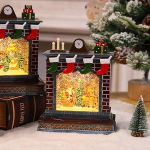 Detail of Santa inside a fireplace snow globe with warm LED lighting and glitter