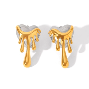 Detail view of heart-shaped lava stud earrings with mixed gold and silver metallic finish