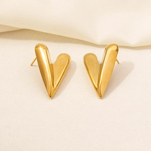 Detail view of 3D heart-shaped gold earrings with polished 18K vacuum plating finish