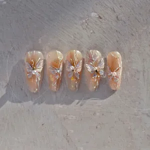 Detail of 3D gradient butterfly nail stickers with pearls and rhinestones on pink glitter