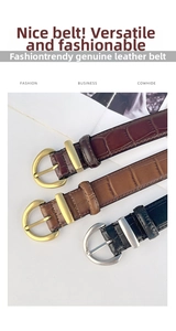 Detail of crocodile textured leather belts in black and brown with D-shape buckles