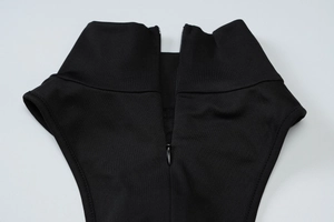 Detail of high neck black dress featuring a seamless invisible back zipper closure