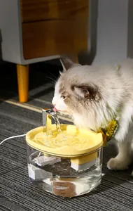 Detail of smart pet water fountain with cat drinking from the quiet flowing water stream