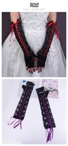 Detailed view of long lace-up fingerless gloves with floral patterns and ribbon ties