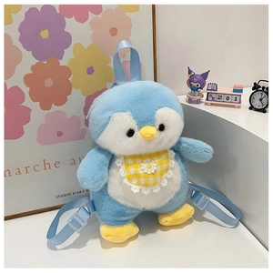 Detail of blue plush penguin backpack with daisy bib in a cozy lifestyle setting