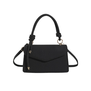 Black textured flap crossbody bag with knotted handle and golden ring hardware for women