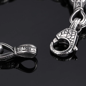 Retro titanium steel bracelet featuring a vintage hand-in-hand pattern and clasp