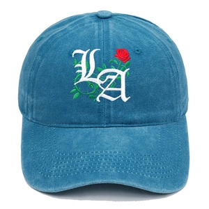Detail of gothic LA embroidery and rose design on washed peacock blue cotton baseball cap