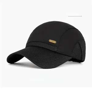 Detail of the breathable mesh fabric and golden logo on the black sports baseball cap