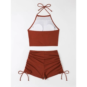 Close-up of rust red ribbed bikini set with halter neck top and side-tie shorts