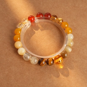 Multicolor tiger eye and amethyst beaded bracelet on minimalist background