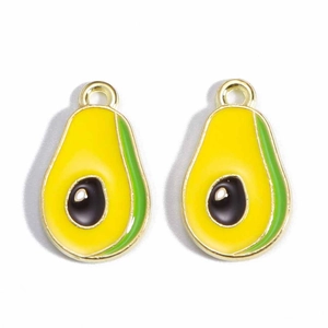 Macro shot of two gold avocado charms with green and yellow enamel for DIY jewelry
