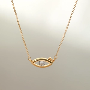 Close-up of gold-plated evil eye pendant necklace with cubic zirconia center stone
