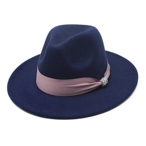 Detail of navy wool fedora hat featuring a pink silk band and sparkling silver rhinestone buckle