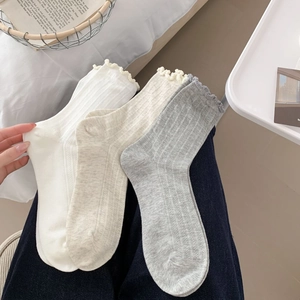 Close-up of thin breathable mesh cotton socks with lettuce edge and vertical stripes