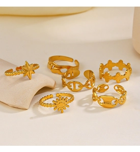 Close-up of assorted gold star and moon adjustable rings displayed on ceramic stands