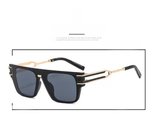 Close-up of modern square sunglasses featuring gold hollow metal temples and black frame