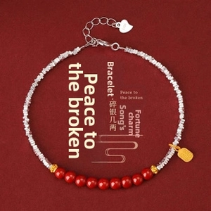 Detail of S925 silver beaded bracelet with red cinnabar beads and a gold Fu pendant