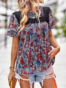 Close-up of floral print top with black lace trim and crew neck detail for summer