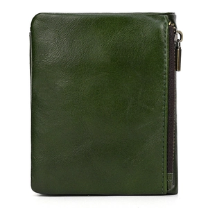 Detail view of deep green leather texture and vertical zipper pocket on folding wallet