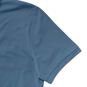 Detail of well-crafted shoulder seam and textured fabric on the light blue polo shirt
