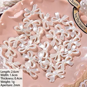 Detailed view of pearl bow beads with dimensions 2.6x1.6cm and 2mm hole for DIY crafts