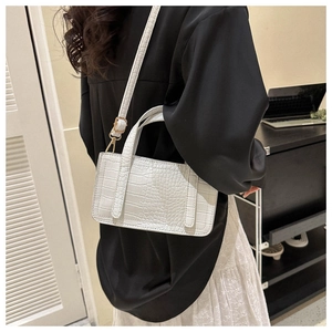 White faux crocodile leather handbag shown worn as a crossbody bag for size reference
