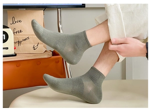 Detail view of grey-green mesh cotton ankle socks with breathable ribbed design for men