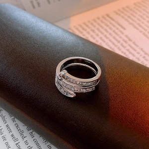Macro shot of silver plated ring with rectangular zircons on a leather texture case