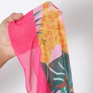 Detail of sheer mesh fabric featuring vibrant floral and leopard prints for swimwear