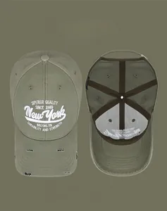 Detail of army green baseball cap with New York 3D embroidery and distressed brim