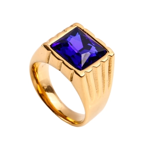 Detailed shot of a gold-finish ring with a large faceted square blue gemstone and grooved sides